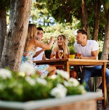 friends having drinks at outside table