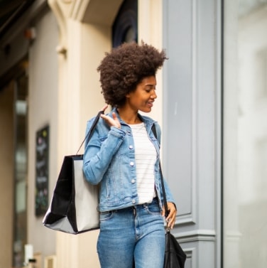 woman shopping carrying bags and smiling